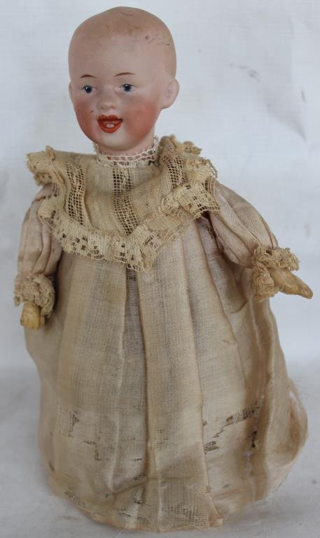 UNUSUAL MECHANICAL BISQUE HEAD DOLL: WIND UP MECHANISM, MISSING RUBBER WHEELS, SIGNED HEUBACH, PRESSED NUMBERS 73, 64, 0, WORN ORIGINAL CLOTHES, 9 1/2" H