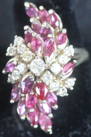 UNMARKED 14K YELLOW GOLD LADIES COCKTAIL RING: SET WITH 15 ROUND DIAMONDS & 20 MARQUIS SHAPED RUBIES, SIZE 8 1/2 - 9, SI GRADE DIAMONDS TOTALING APPROX. 1 CT.