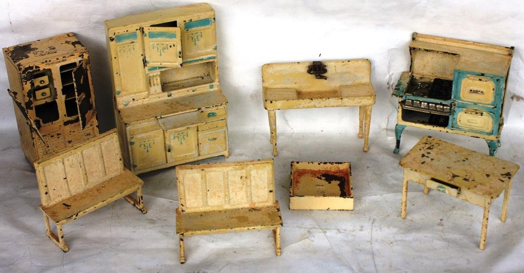 COLLECTION OF 8 PCS. OF ARCADE CAST IRON DOLLHOUSE: FURNITURE, TO INCLUDE, 5" H SINK, 6" H RANGE, MISSING BACK LEG, 8" HOOSIER STYLE CABINET, TWO 4" H BENCHES, 1" SHOWER STALL, 6 1/2" FRIGIDAIRE TWO DOOR REFRIGERATOR, ONE HINGE AS IS AND MISSING BACK F