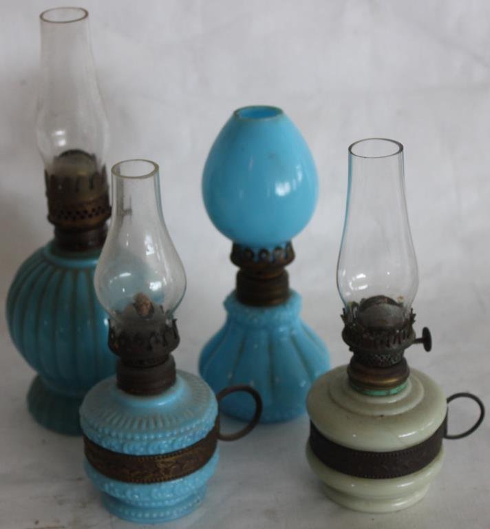 LOT OF 4 MINI OIL LAMPS-3 BLUE MILK GLASS, 1: CUSTARD GLASS, 2 WITH BRASS FINGER RINGS, 1 WITH BLUE SHADE. 6.25"H TO 8.25"H