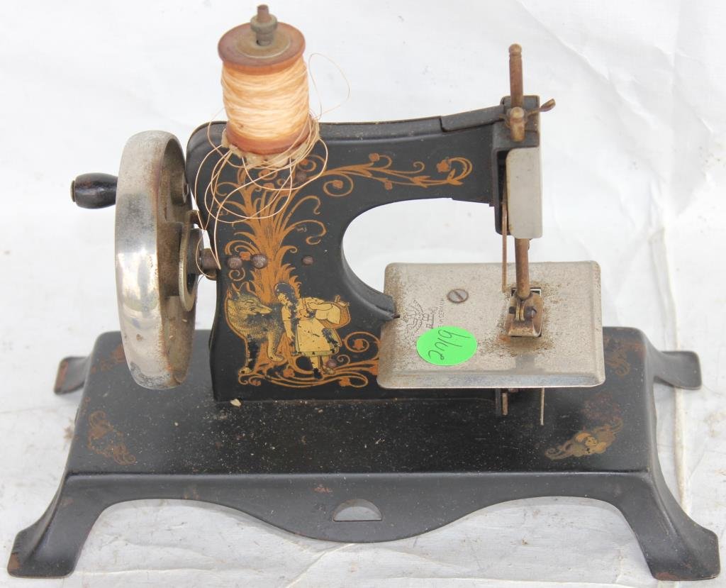 CHILD'S SEWING MACHINE WITH ORIGINAL DECORATION: 7 1/4" H, 9" W, 4 1/4" D