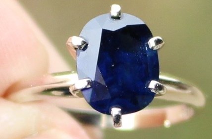14K PLUMB WHITE GOLD RING W/ 3 CARAT SAPPHIRE: 3.1G, SZ 7, SAPPHIRE IS OVAL MIXED CUT, HAS COLOR GRADE OF 5.0, 55% BRILLIANCE AND IS 2.97 CARATS, INCLUDES $2,100 REPLACEMENT VALUE COST APPRAISAL FROM IGI AND HGC APPRAISAL FROM 1983 WITH REPLACEMEN