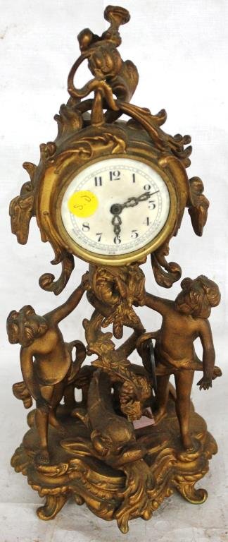 ORNATE FIGURAL METAL CLOCK BY NEW HAVEN WITH: CHERUBS AND DOLPHIN, GLASS MISSING. 15"H X 6"W