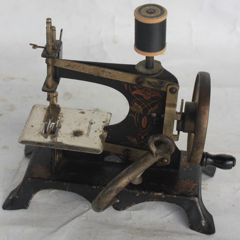 2 DECORATED TIN CHILD'S SEWING MACHINES, SHOWS: WEAR TO PAINT, 5" & 6 1/2"H AND 4" TO 7"W