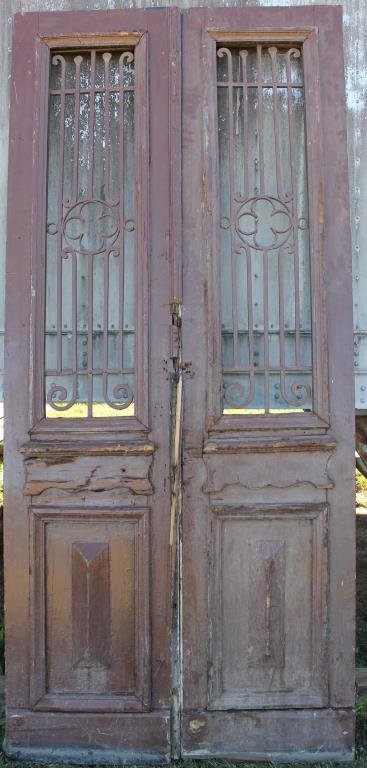 PAIR TALL BROWN DOUBLE DOORS WITH RAISED: PANELS, IRON GRATES, 97 1/2" X 44 1/2"