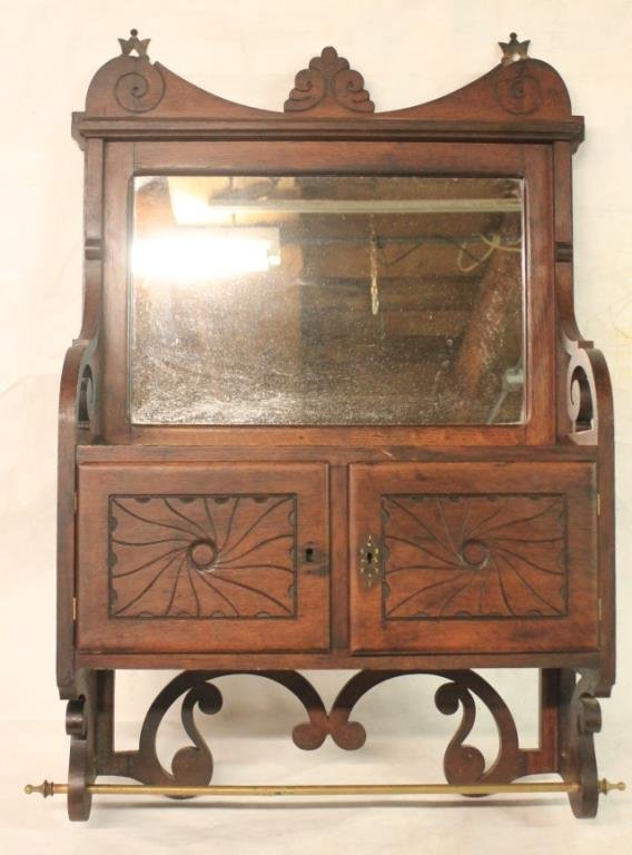 VICTORIAN OAK HANGING CABINET W/ MIRRORED TOP: 2 DOORS AND BRASS TOWEL RAIL, ORIGINAL FINISH, 32"H X 21 1/4"W X 7 3/4"D, MISSING 1 ESCUTCHEON