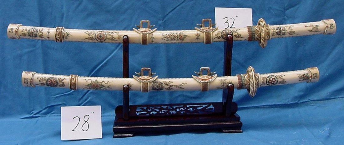 ANTIQUE CHINESE OX BONE SWORDS ON WOOD STAND QING DYNAS: Exceptional antique set of swords, all hand carved from antique Ox bones. It appears light yellow color. The upper one is 32" long and the lower one is 28". Both sitting on a wooded rack. Dragon or fl