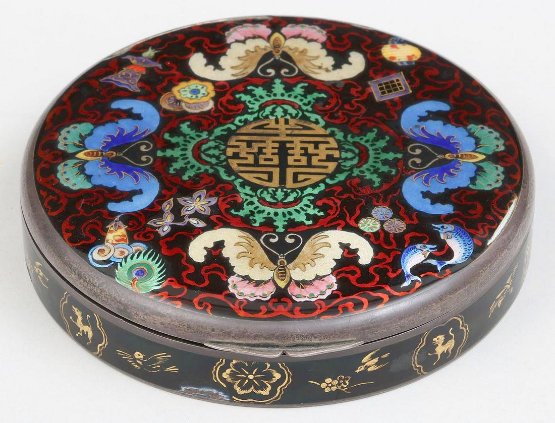 .935 silver and enamel box: .935 silver and enamel round butterfly decorated box with painted gilt highlights, marked. Chips to enamel, lid slightly misshapen. 1-1/4''h, 5-1/4''dia. Total approximate weight 14.6 troy oz.