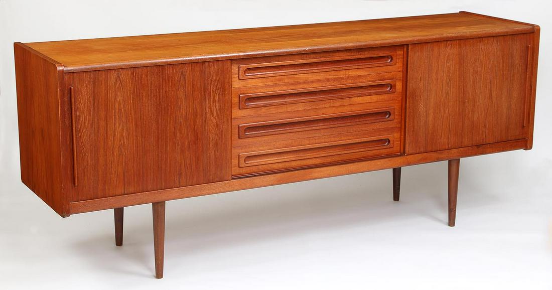 Danish Modern sideboard: Danish Modern sideboard with two slide door cabinets flanking four center drawers, set on tapering round legs, mid 20th century. Wear from use with minor stains, scratched and chip to bottom corner. 3