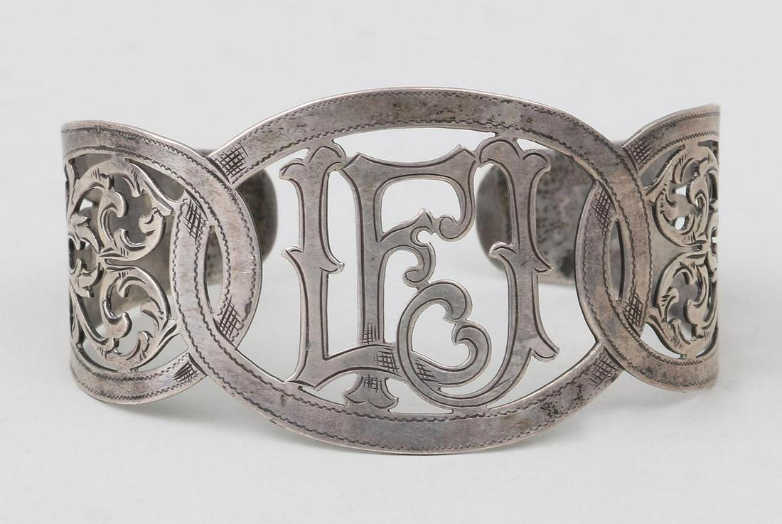 Pierced silver cuff, monogrammed ''LFJ'' with scro: Pierced silver cuff, monogrammed ''LFJ'' with scroll decoration, unmarked. 1-1/2''h, 2-1/2''w. Provenance: Acquired direct from artist Leon Foster Jones' estate.
