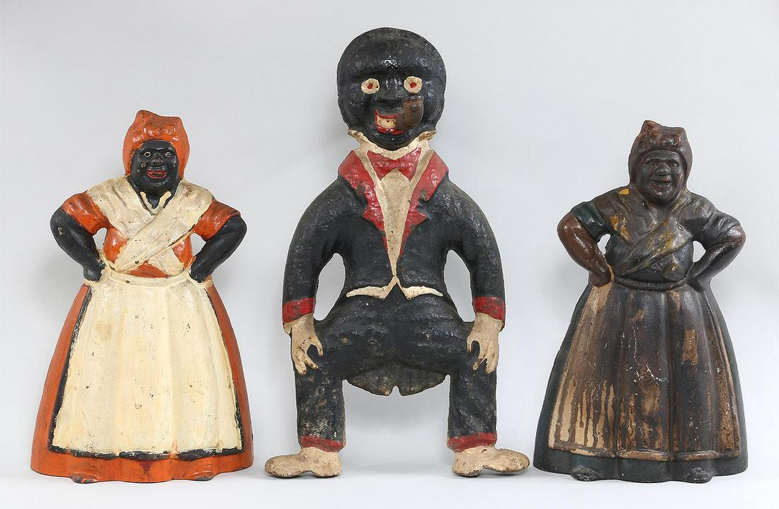 Group of (3) Black Americana: Group of (3) Black Americana cast iron painted items, to include: (2) mammy doorstops, (wear to paint on one); and 19th century pipe smoking with arms akimbo single andiron, (lacking dog). Largest 16'