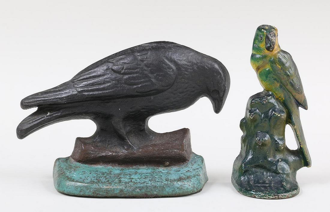 Group of (2) cast iron polychrome doorstops: Group of (2) cast iron polychrome doorstops, to include: parrot perched on stump; and crow. Surface wear. Crow 5-3/4''h, 8''w, 3''d.