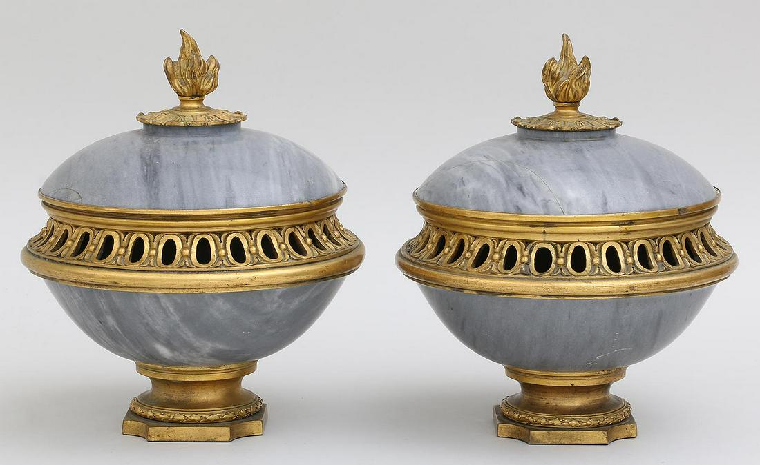 Pair of large marble and gilt bronze: Pair of large marble and gilt bronze footed garnitures with flame finials. Cracks to marble and top unattached to one. 9''h, 7-3/4''dia.