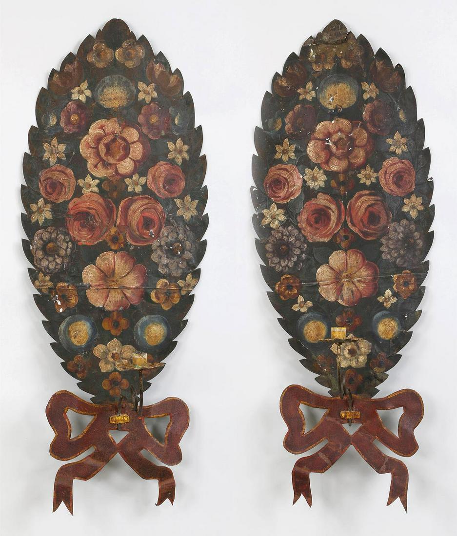 Pair of sheet metal ribbon form sconces: Pair of sheet metal ribbon form sconces with hand painted flowers. Some splits and losses. 32''h, 12''w.