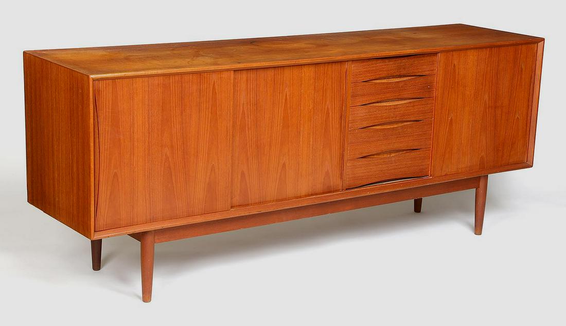 Scandinavian mahogany credenza: Scandinavian mahogany credenza with five stacked drawers flanked by double slide door cabinet and single slide cabinet. Staining to top, wear from use. 31''h, 77''w, 19''d.