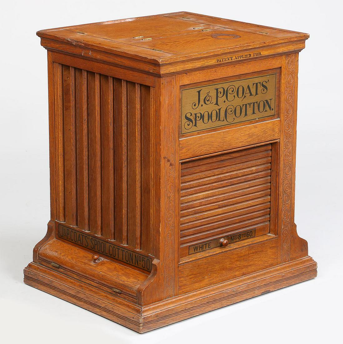 J.P. Coats spool cotton rotating display cabinet: J.P. Coats spool cotton rotating display cabinet, having four sides, two with tambour roll up doors, top with lift doors for loading. Wear from use, missing glass covers to vertical displays. 23''h, 2
