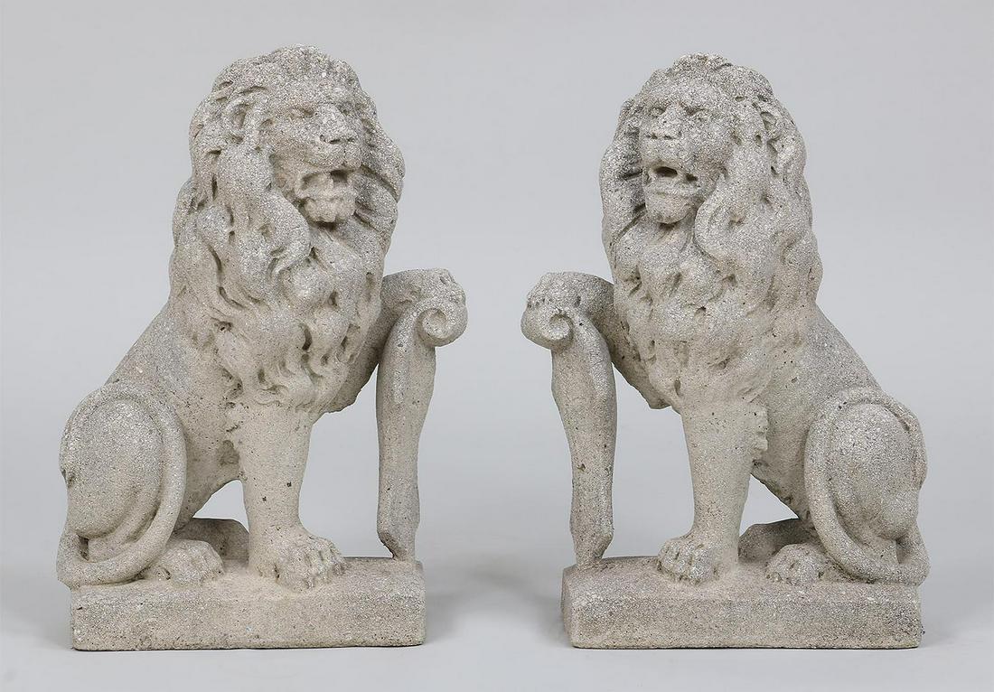 True pair of small crushed stone lions: True pair of small crushed stone seated lions holding shield. One with loss to back corner. 20''h.