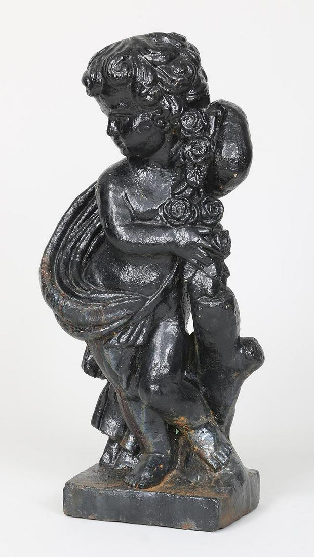 Cast iron figural garden statue: Cast iron figural garden statue of putto draped in cloth and roses, painted black. Split to leg, possible repair. 24''h.