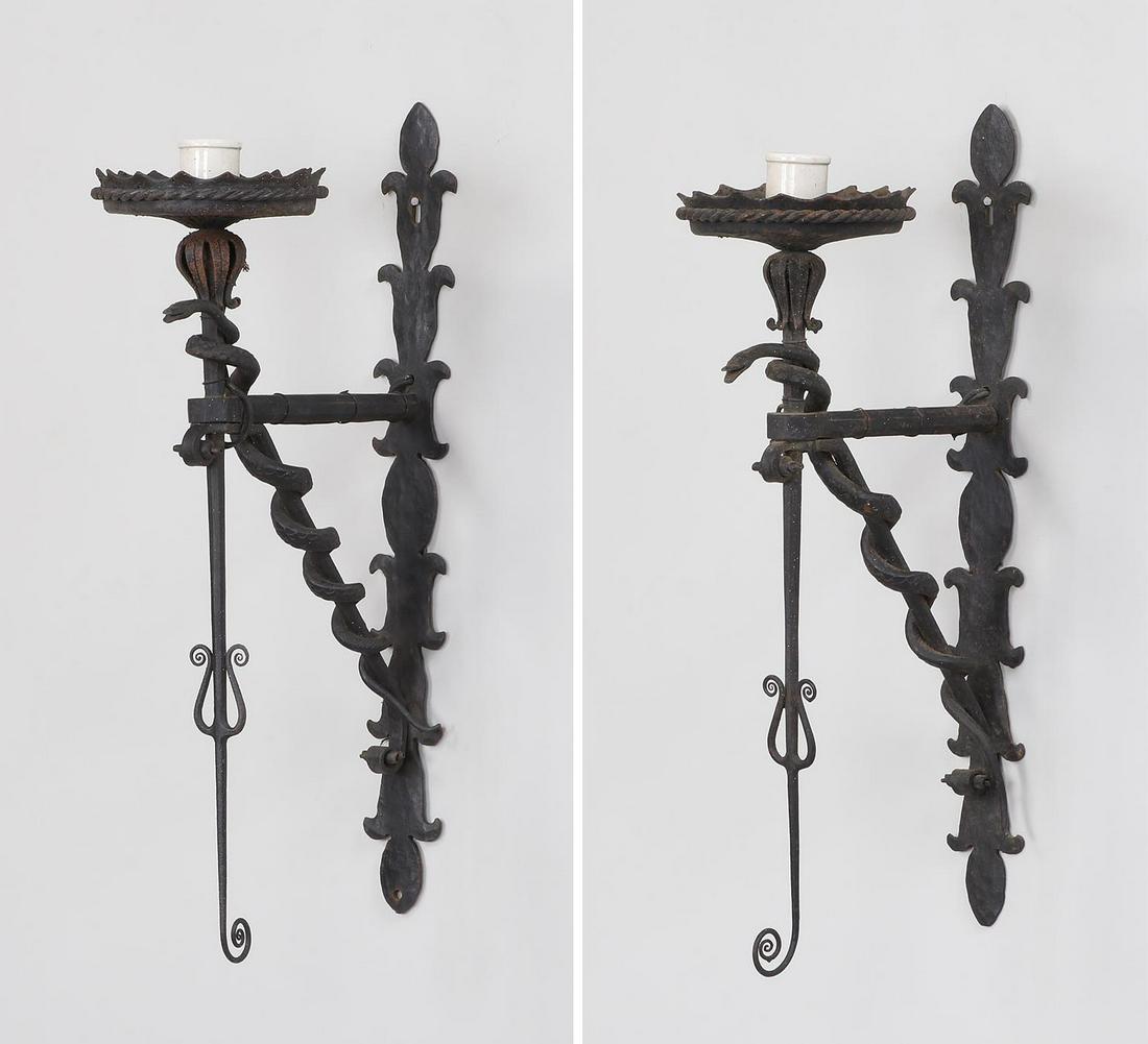 Pair of hand wrought iron sconces: Pair of hand wrought iron sconces with snakes. 22''h, 6''w, 11''d.
