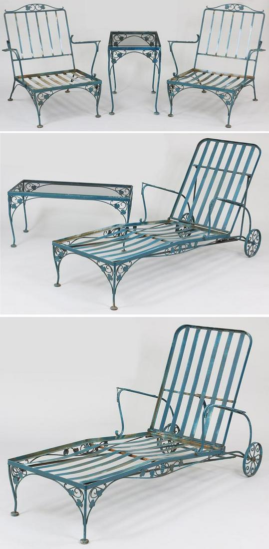 Six piece wrought iron patio set: Six piece wrought iron patio set, to include: pair of armchairs; assembled pair of recliners; and two small glass top rectangular side tables. Smaller table with slightly oversized top, one recliner n