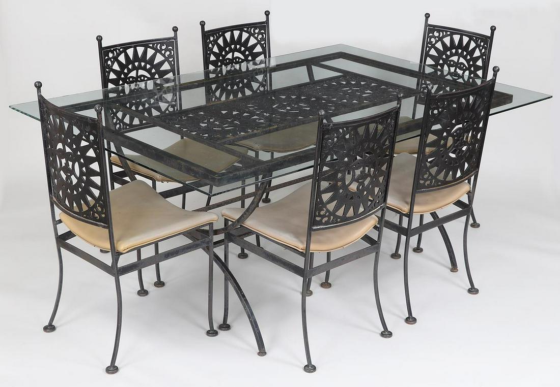 Arthur Umanoff seven piece patio set: Arthur Umanoff seven piece patio set in iron with zinc cutout sun face plaques, painted black. Some rust and paint loss, some holes to vinyl upholstered seats. 28-1/2''h, 68-1/4''w, 46''d.
