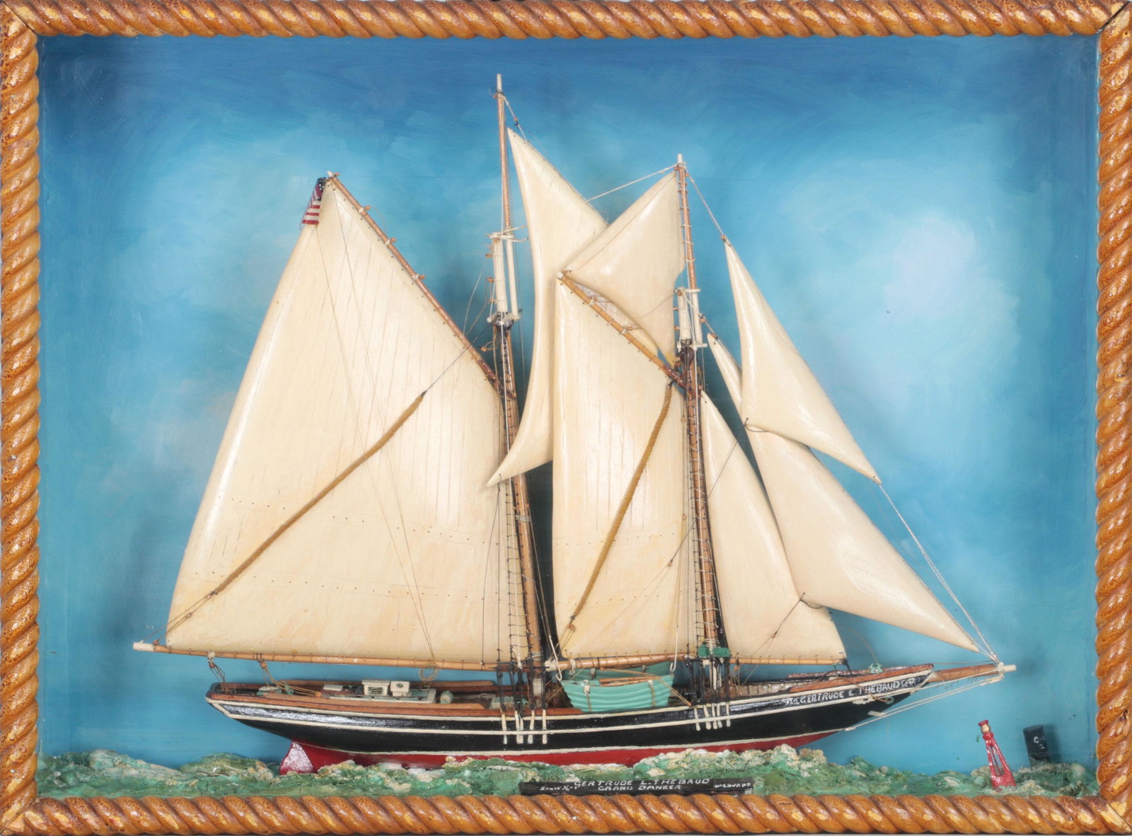 Carved and painted wood ship diorama: Carved and painted wood ship diorama of Gertrude L. Thebaud, housed in shadow box with hand painted plaque reading ''Gertrude L. Thebaud, Grand Banker, W.S. Burns, Scale 1/8''=1''', 20th century. One 