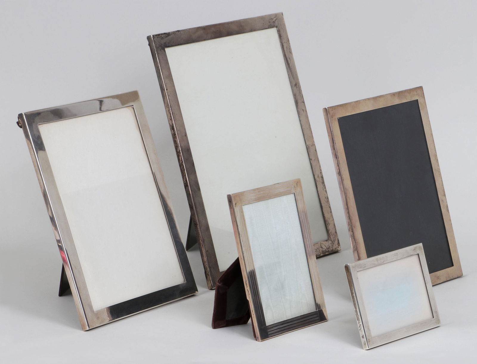 Group of (5) sterling silver Tiffany & Co.: Group of (5) sterling silver Tiffany & Co. and Tiffany & Co. Makers graduated rectangular picture frames, including: large frame; frame with linear chasing; and monogrammed frame; etc. All marked. Lar