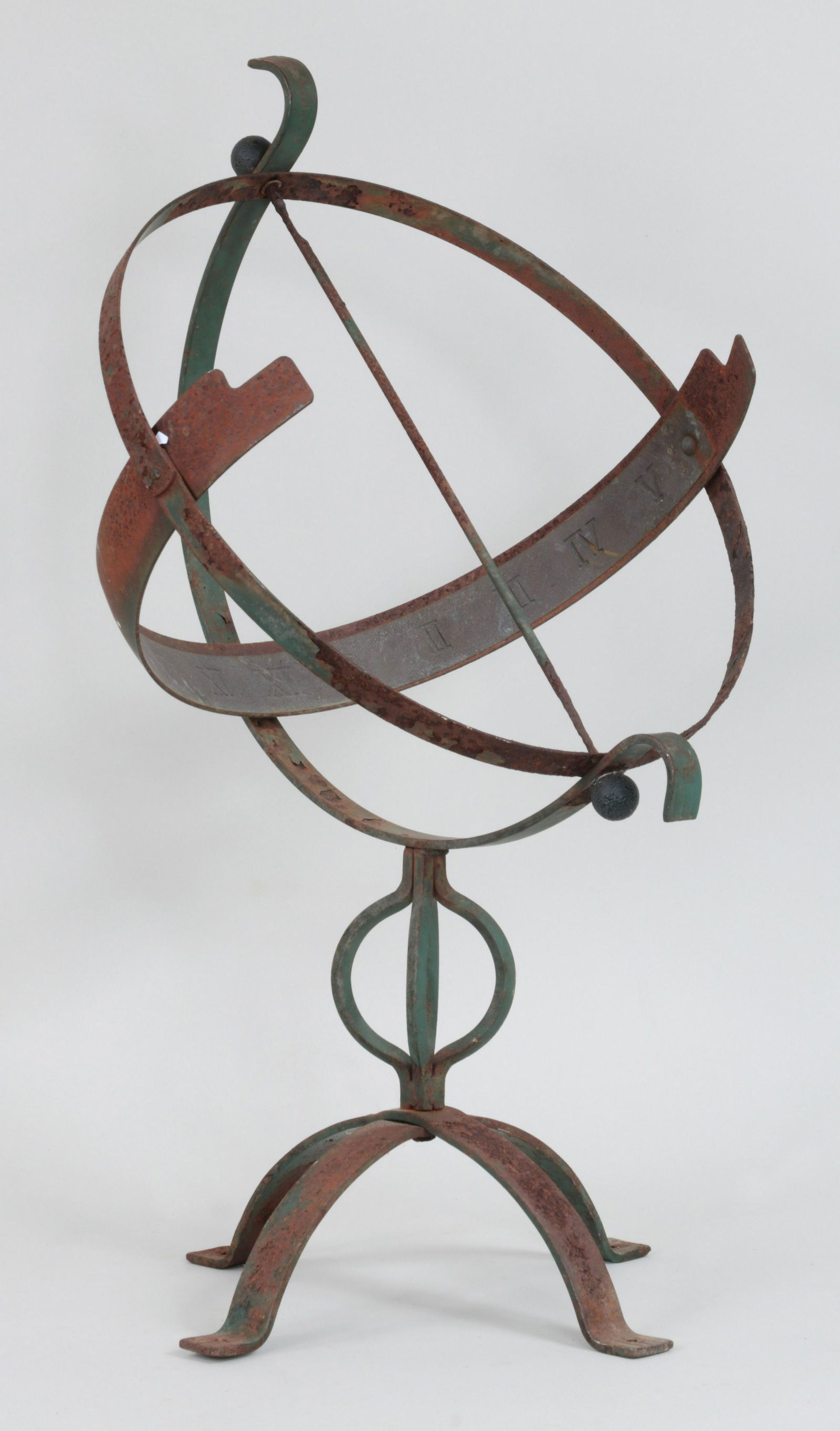 Wrought iron armillary: Wrought iron armillary on four feet in green. Paint loss, rust. 25-1/2''h, 15''w, 16-1/4''d.
