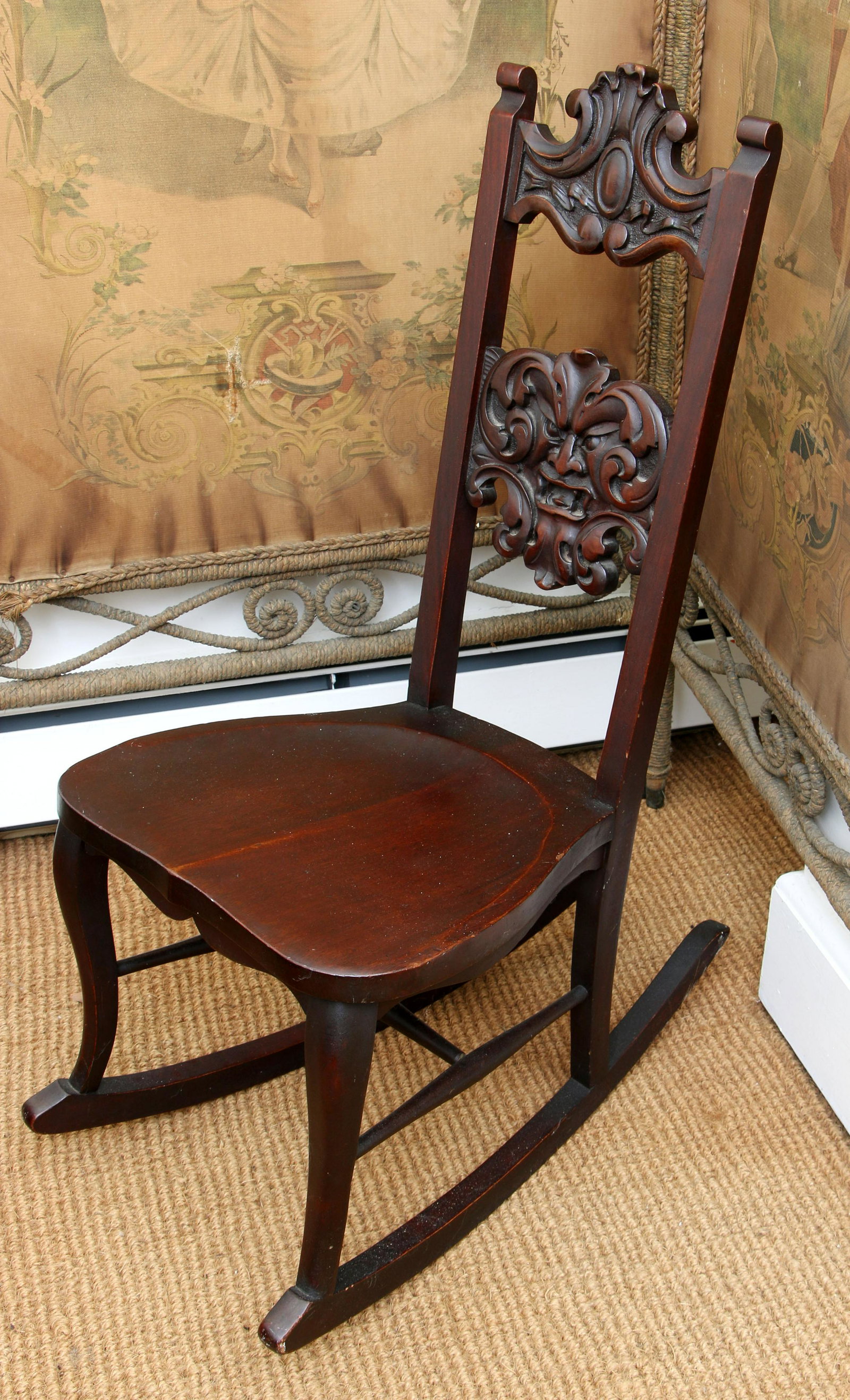 Carved mahogany rocking chair: Carved mahogany rocking chair with Northwind face, by Stickley & Branot Chair Co., paper label. 36-1/4''h.