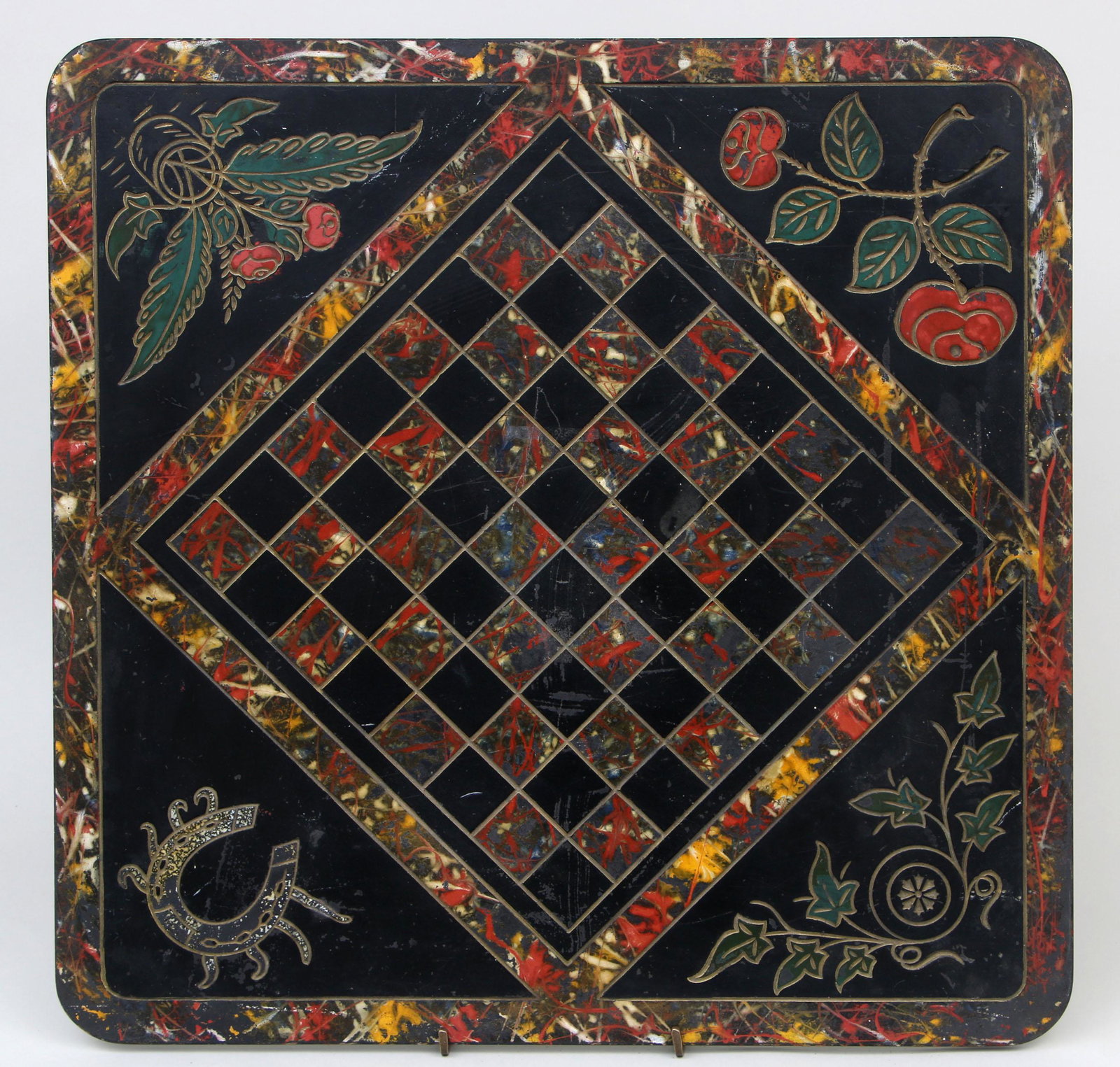 Painted slate chess board: Painted slate chess board with engraved accents to corners such as horse shoe, flowers, and ivy, 19th/20th century. Surface wear. 22''h, 22''w.