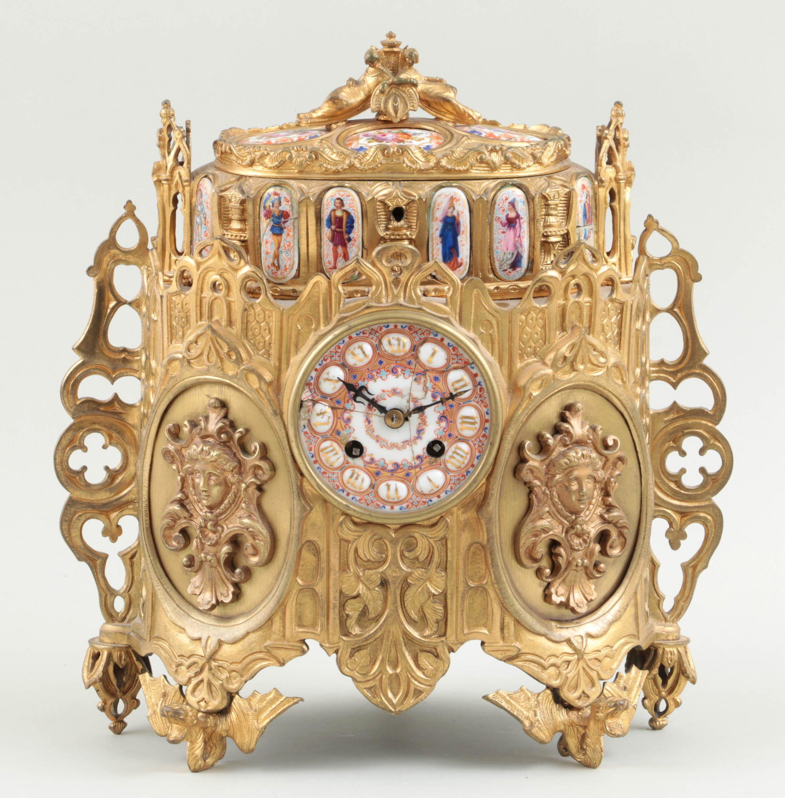 19C bronze jewelry box and clock: 19th century gilt bronze jewelry box and clock with figural and floral porcelain panels. Cracks and worn paint to porcelain. 13''h, 12-1/4''w, 7''d.