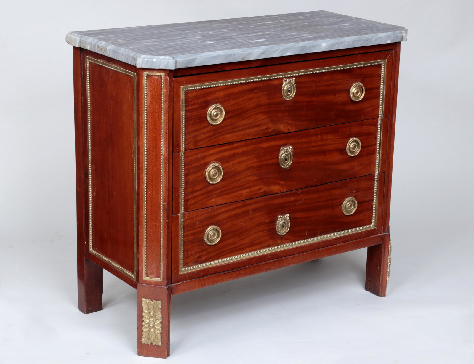 French Empire marble top commode: French Empire bronze mounted marble top commode with three drawers. Wear from use, small repairs to top. 33-3/4''h, 37-1/2''w, 18-1/2''d. Provenance: Purchased at Sotheby's by present owner.