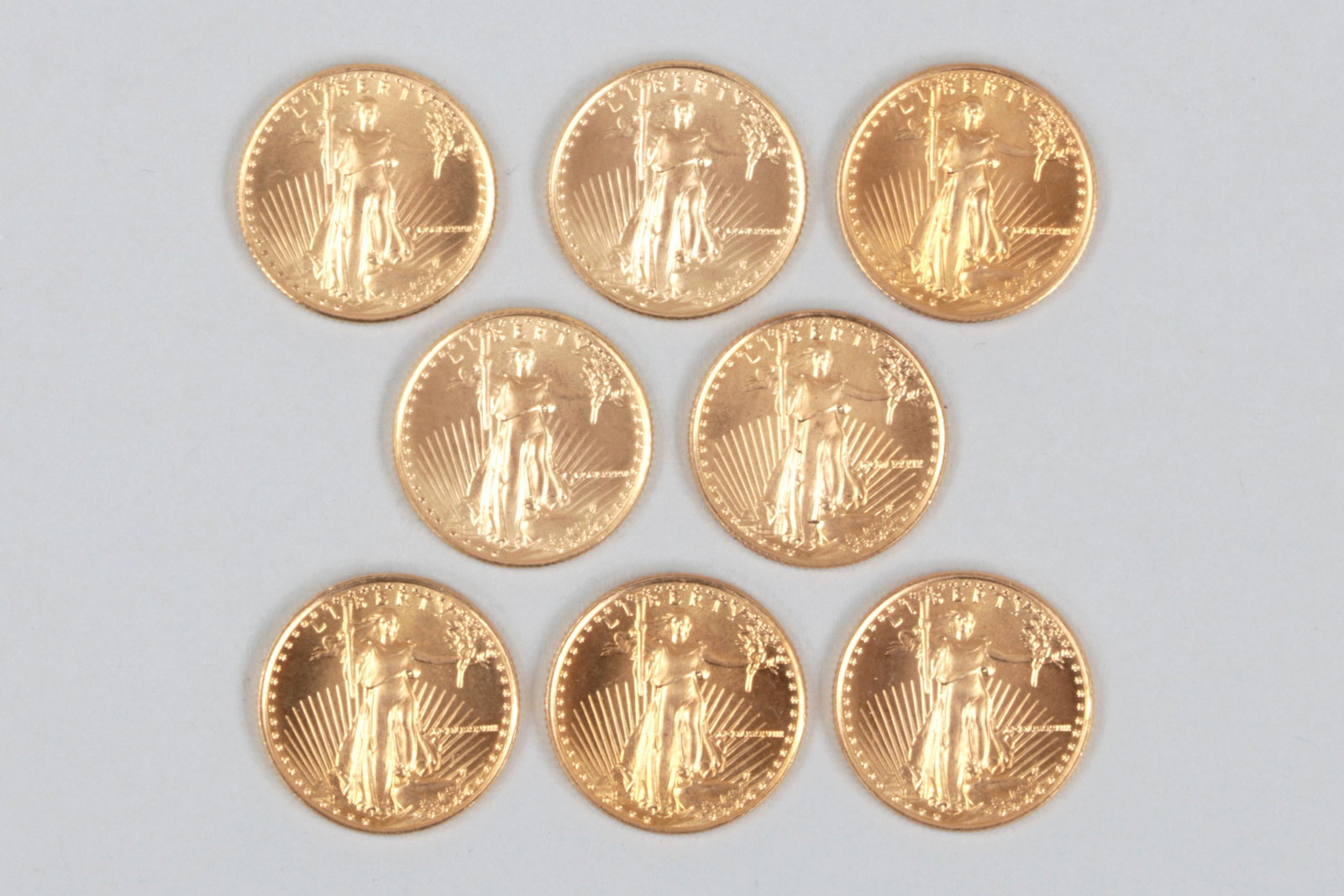 (8) American Gold Eagle five dollar gold coins: Group of (8) American Gold Eagle five dollar gold coins, to include: (3) dated 1986; one dated 1987; (3) dated 1988; and one dated 1989. 16.5mm dia. Total approximate weight 17.5 dwt. Total face value