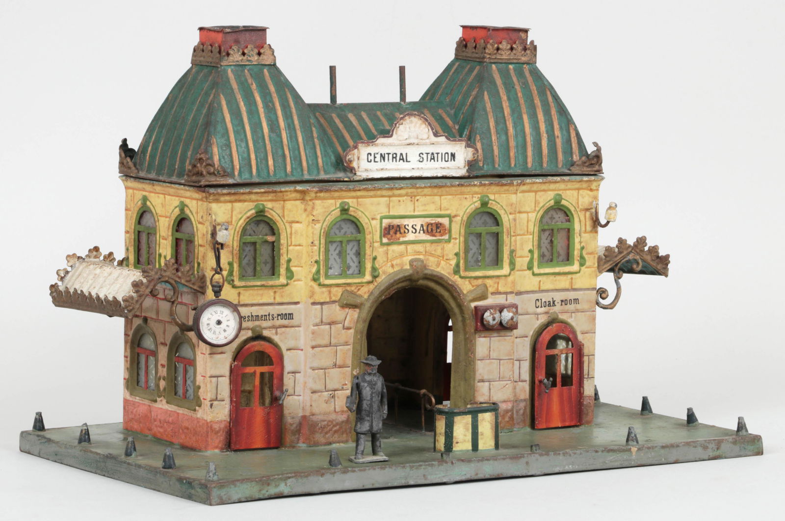 Marklin Central Station hand painted tin model: Marklin Central Station hand painted tin model, with English signs for ''Refreshments-room'' and ''Cloak-room''. Wear to paint, lacking multiple accents. 9-1/4''h, 13-3/4''w, 8-1/8''d.
