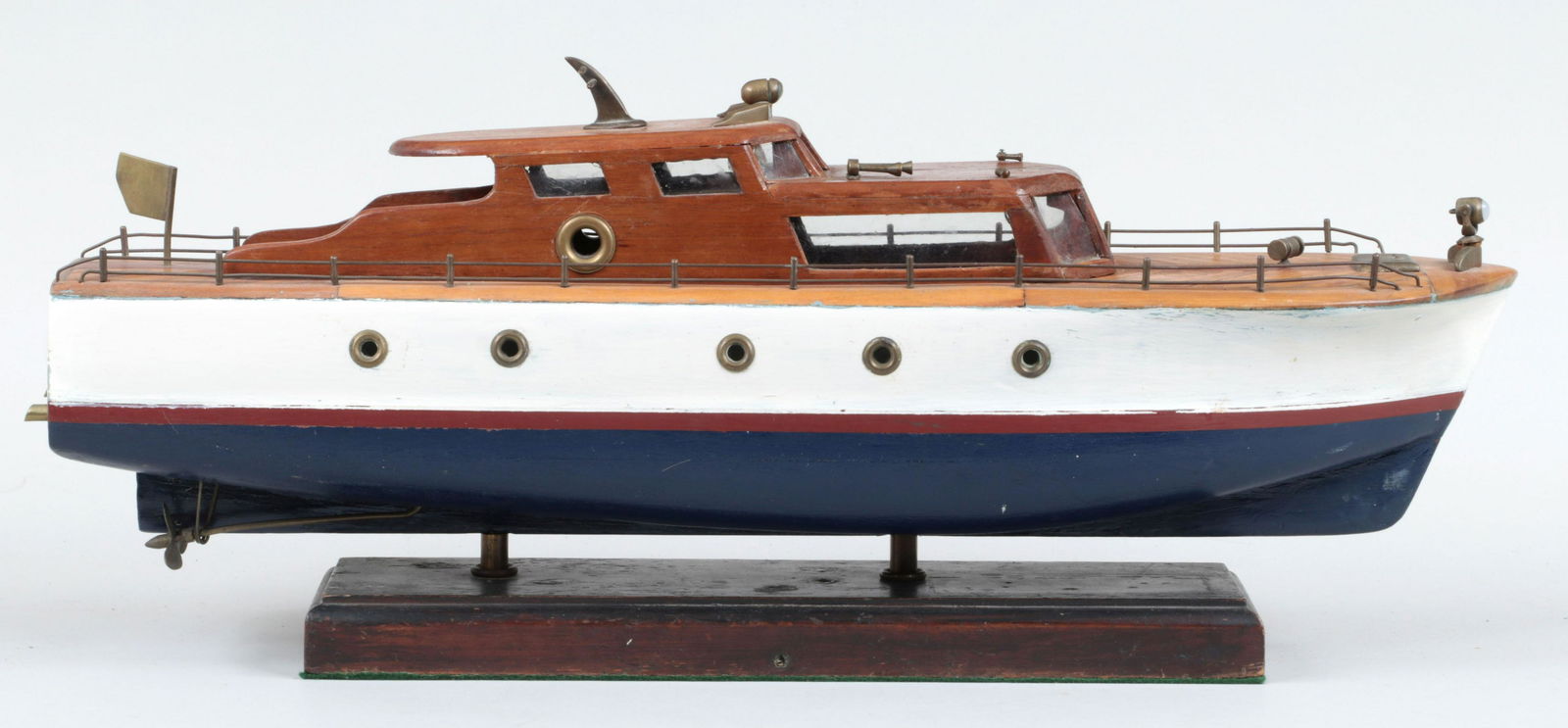 Motor yacht ship model: Motor yacht ship model with details such as boat horns and portholes, mounted on wooden base. Minor wear to paint. Overall 11''h, 6-1/4''w, 26-1/2''d.