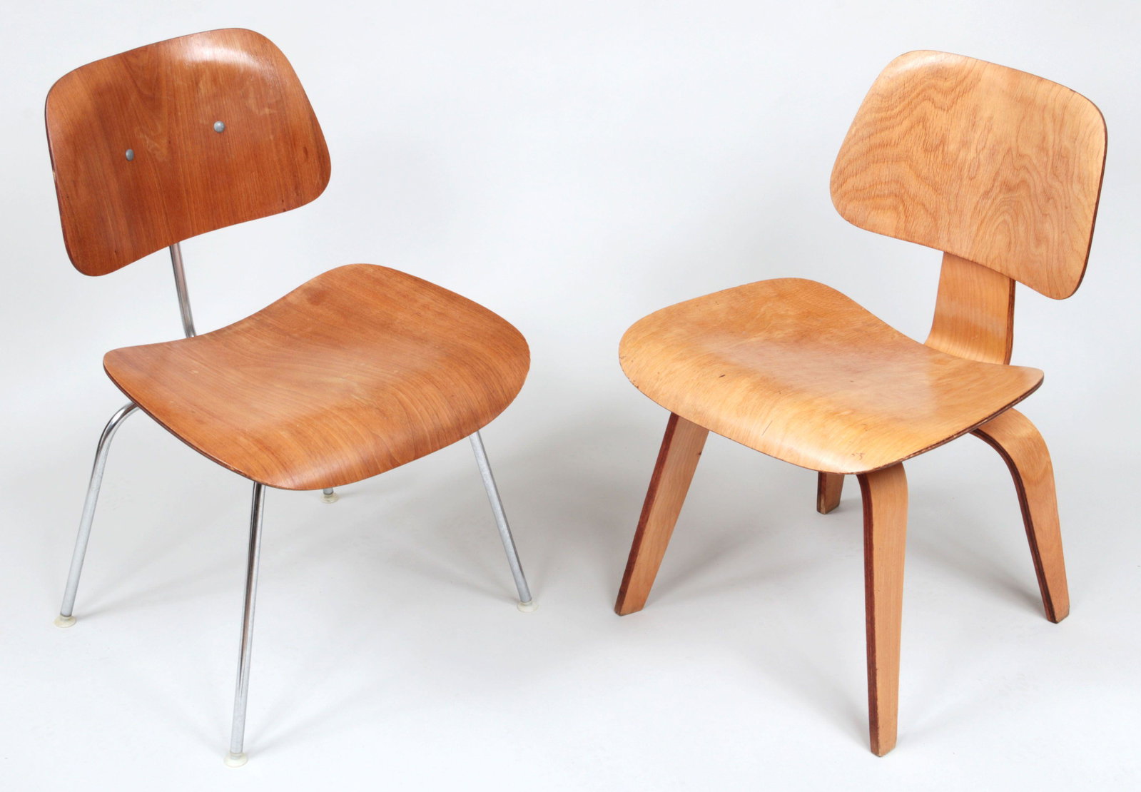 DCM chair and LCW chair: Group of (2) Charles and Ray Eames for Herman Miller chairs to include a DCM chair and LCW chair, both with labels to bottom, 1960's. Wear from use, some replaced screws and bumpers. LCW 30-3/4''h, 19