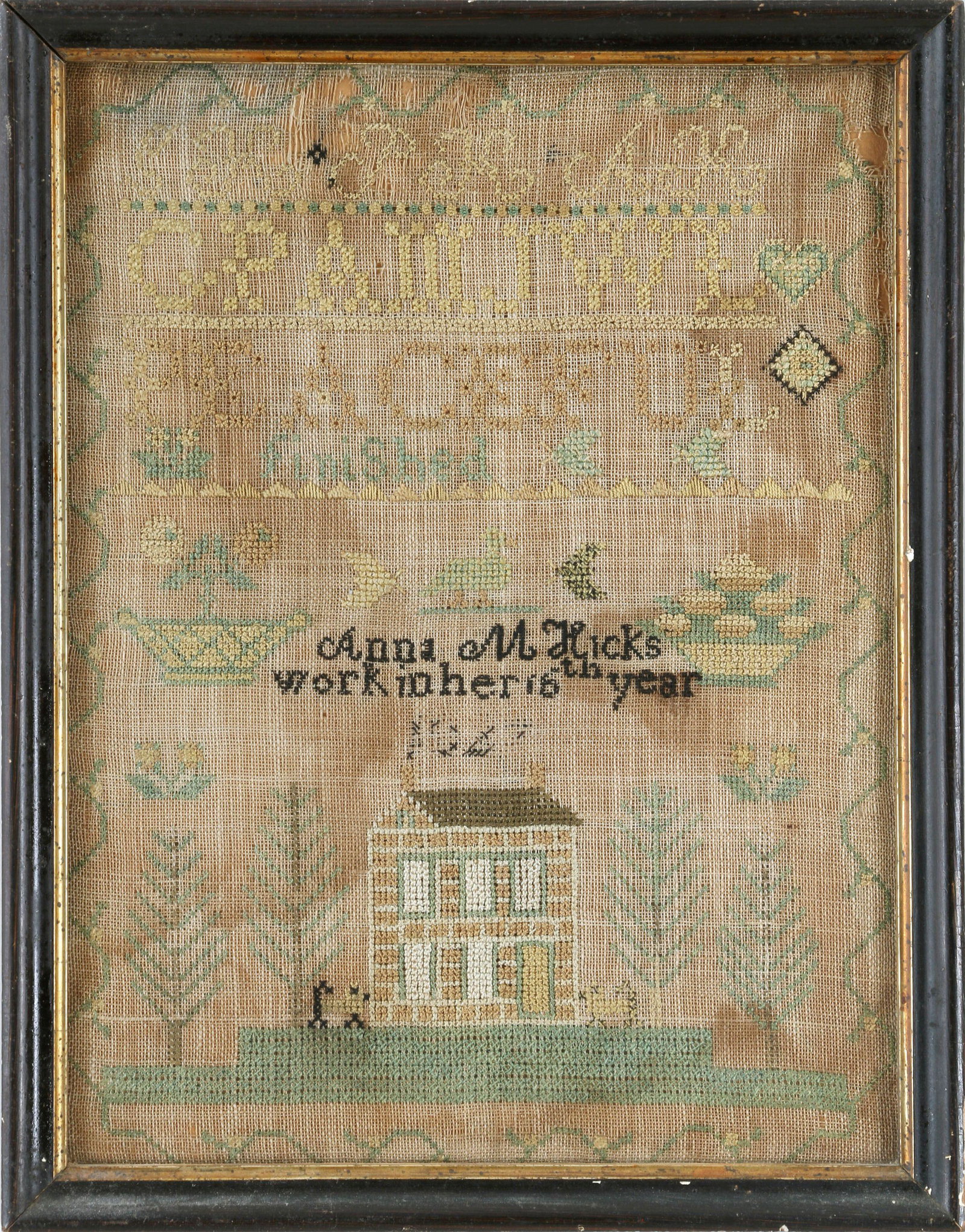 American needlework sampler: American needlework sampler made by Anna M. Hicks, 16, 19th century, with border, house, and tree. Staining, wear, and losses. Under glass. Sight 12-1/4''h, 9-1/4''w.