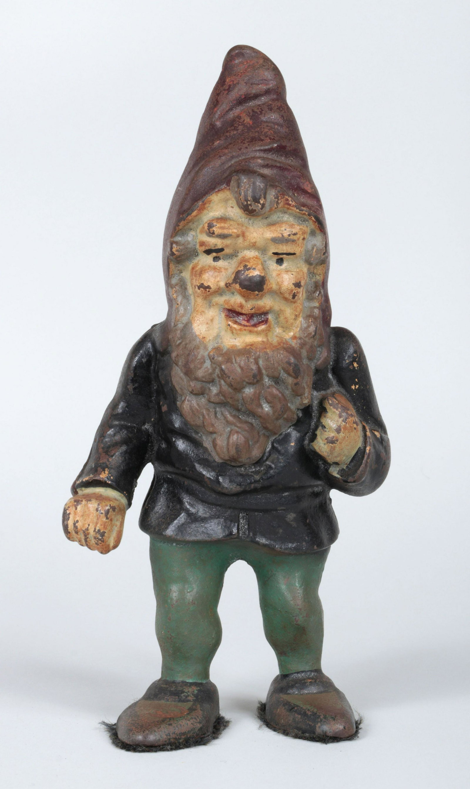 Gnome doorstop: Polychrome painted cast iron gnome doorstop. Wear to paint. 10-3/4''h, 5''w, 3-1/2''d.
