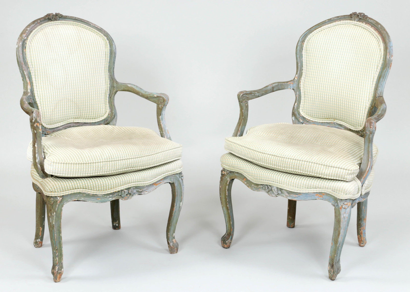 Pair of Louis XV carved open armchairs: Pair of Louis XV carved open armchairs in distressed slate blue paint. Several restorations and losses, stained upholstery. 35''h, 23''w, 21-3/4''d.