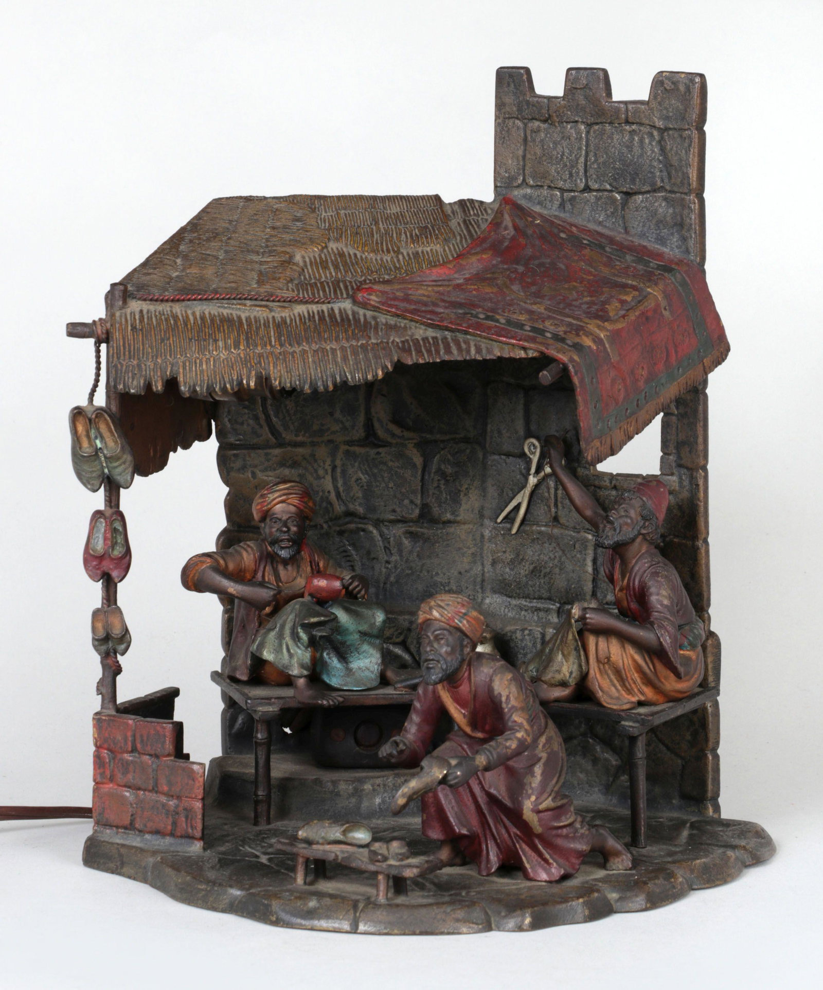 Cold painted Vienna bronze: Cold painted Vienna bronze table lamp with Orientalist cobbler shop scene, marked ''FBK'' and ''B. Altman & Co.'' to bottom. Merchant in front lacking hand tool, minor wear to paint. 9-1/4''h, 7-5/8''