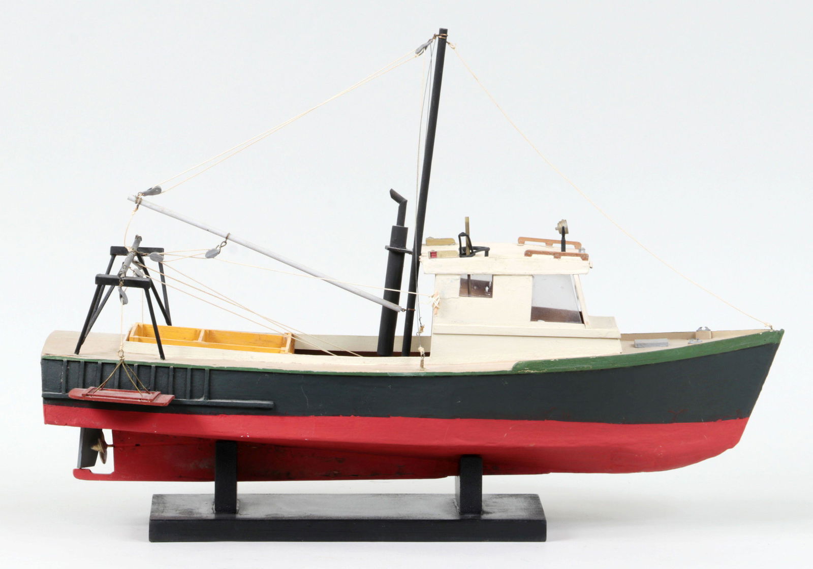 Lobster boat model: Lobster boat model flanked by two dredges and resting on wood mount. Repair to smoke stack and split to body of boat. 15''h, 10''w, 22-1/2''d (including mount).