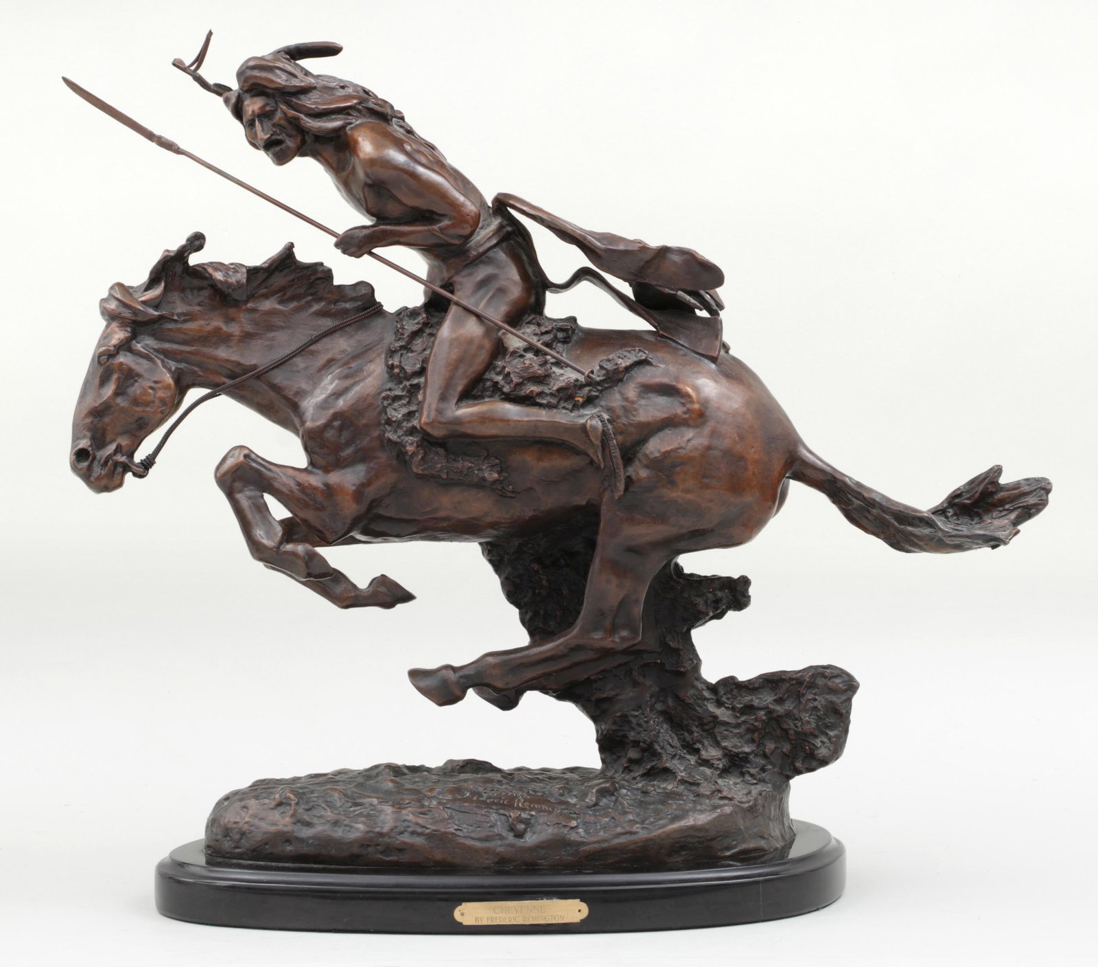 After FREDERIC REMINGTON: After FREDERIC REMINGTON (American, 1861-1909), ''Cheyenne'', bronze with brown patina, signed. Whip slightly loose where attached to hand. 19-1/2''h (including 1-1/4''base), 22''w, 8-3/4''d.