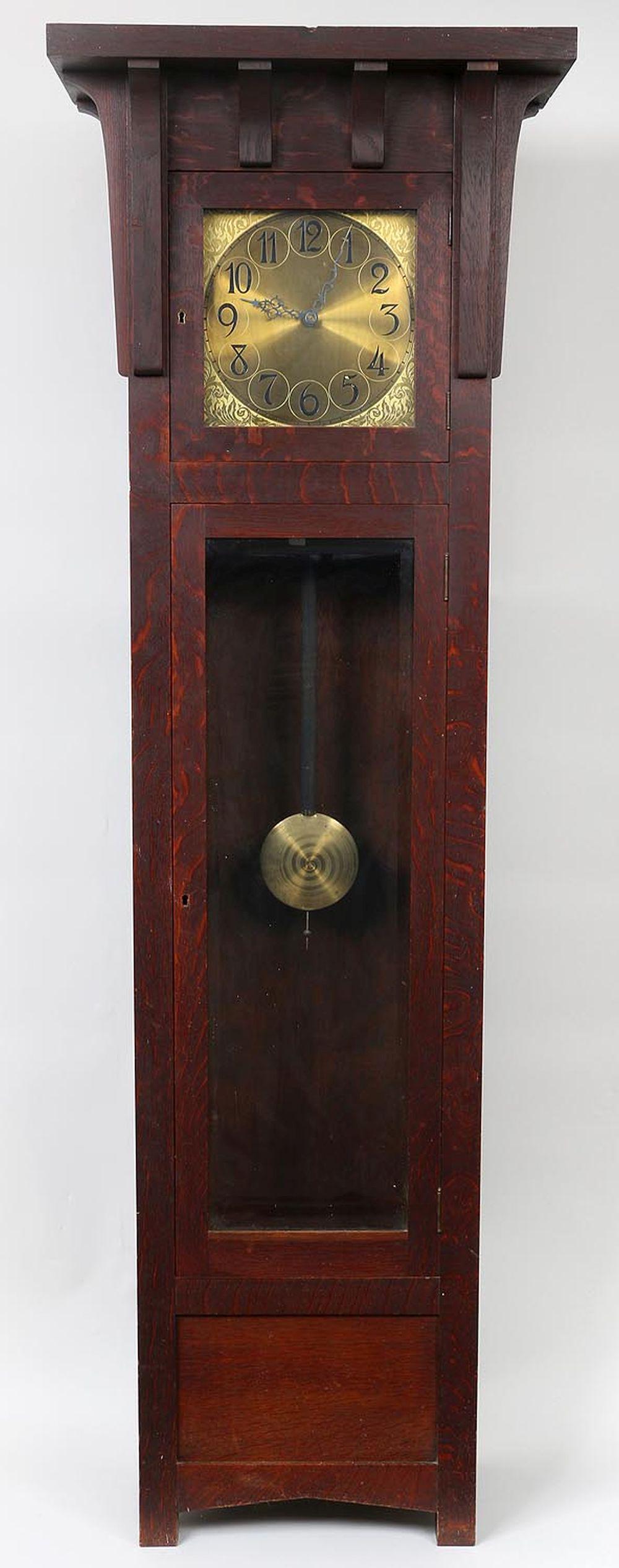 Arts and Crafts oak tall case clock: Arts and Crafts oak tall case clock, by Colonial Manufacturing Co., paper label to back. Wear from use, missing bottom lock, inside bottom board partially missing, ding to top. 84-1/2''h, 27-1/4''w, 1
