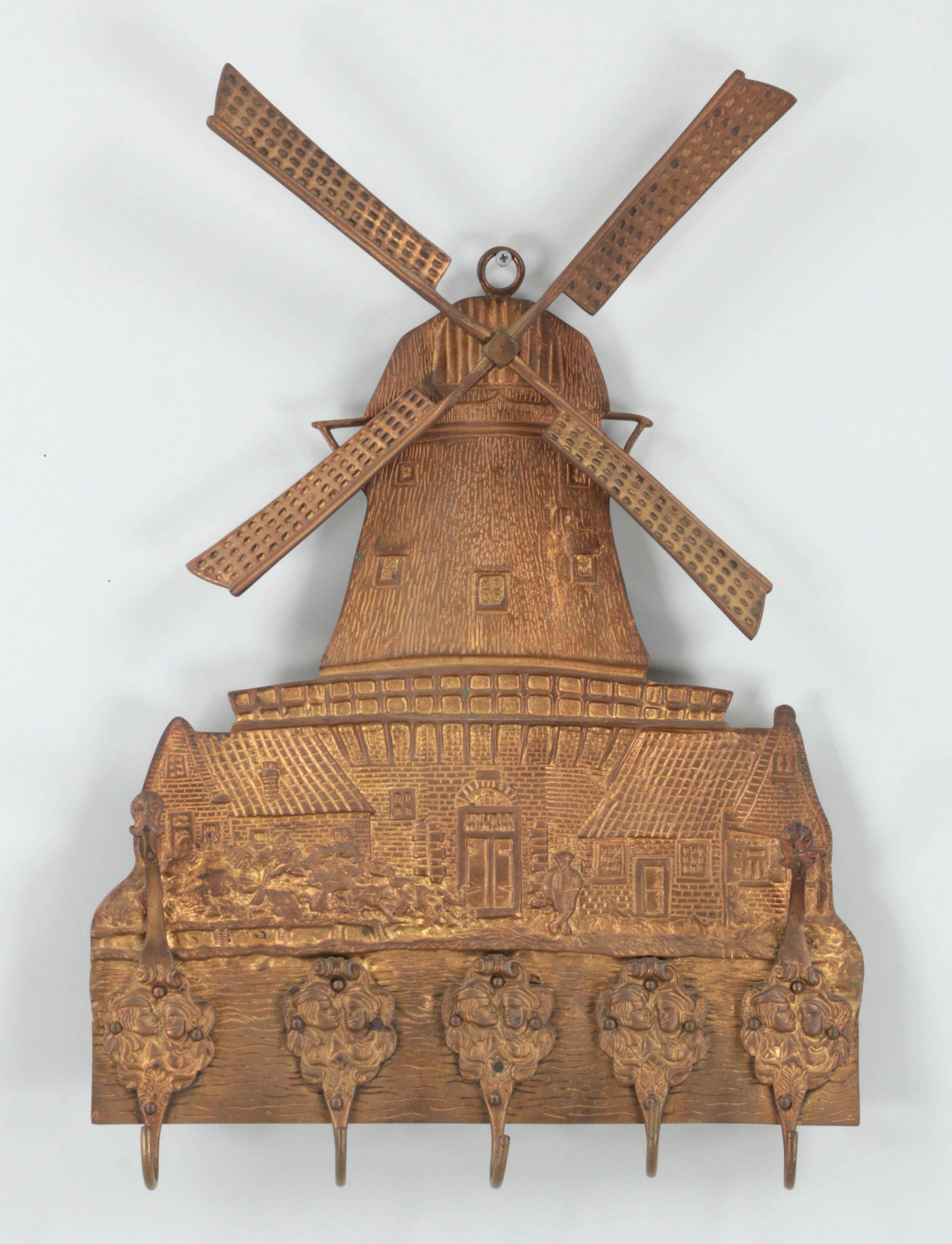 Wall mounted gilt bronze coat rack: Wall mounted gilt bronze coat rack with windmill relief and rotating sails. 24''h, 15-1/2''w.