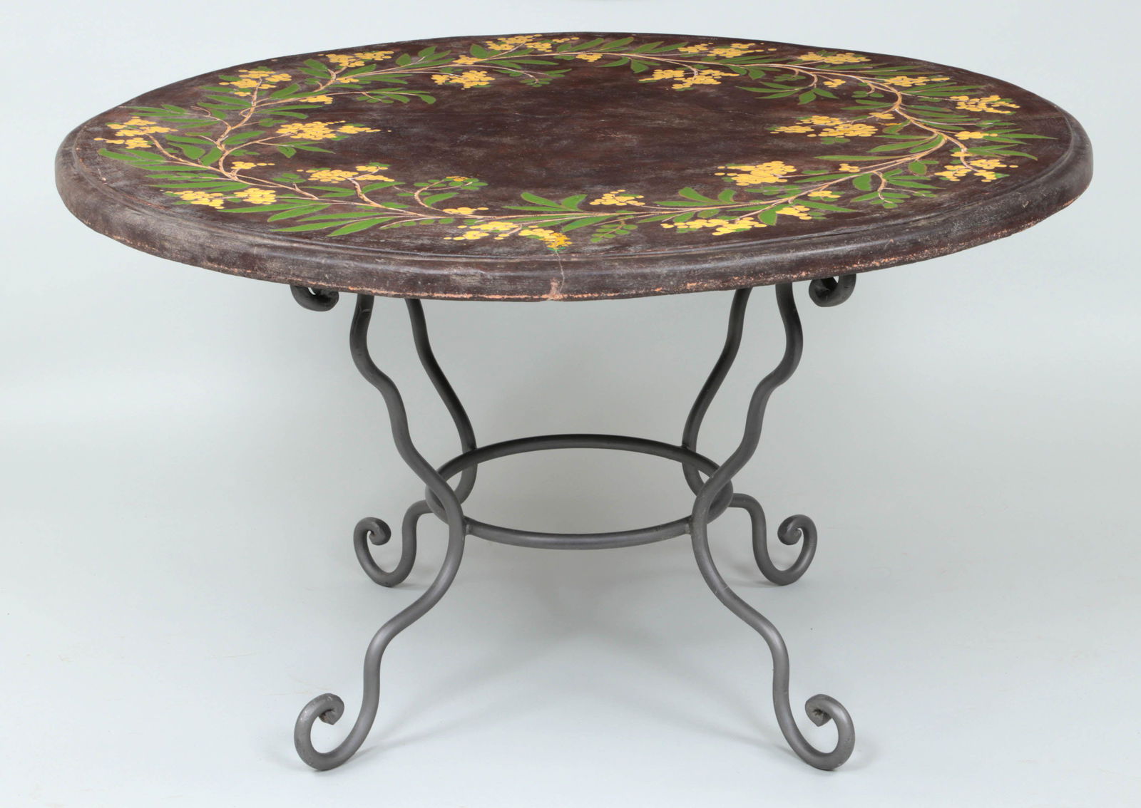 Large painted terra cotta patio dining table: Large painted terra cotta patio dining table with floral decoration. Hairlines and minor surface loss. 29''h, 51''dia.