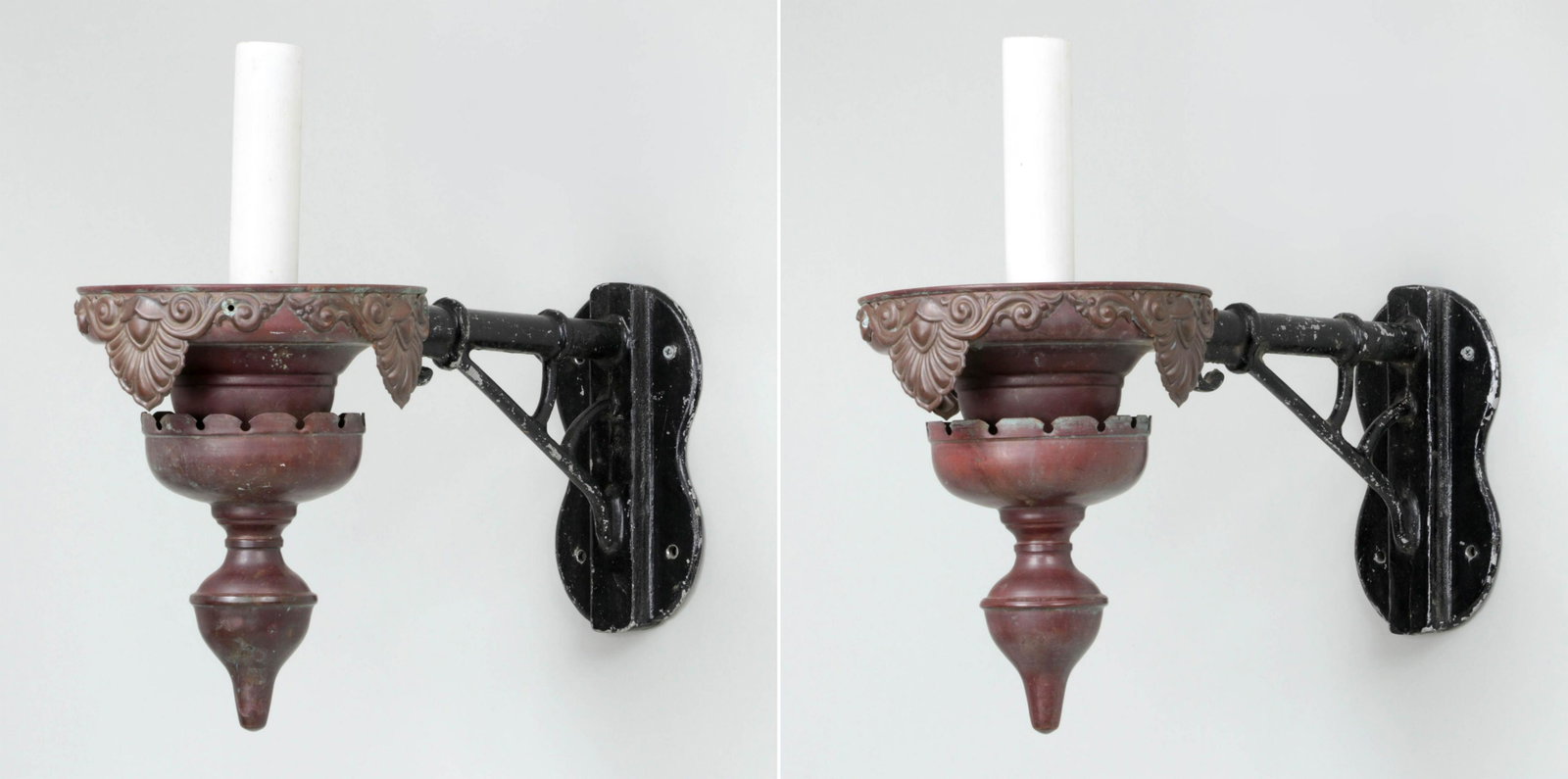 Pair of copper wall sconces: Pair of copper wall sconces with drop finials and black-painted arms, (added later), marked ''Macton''. Dent to one, oxidation. 16-3/4''h, 8-1/4''w, 19-1/4''d.