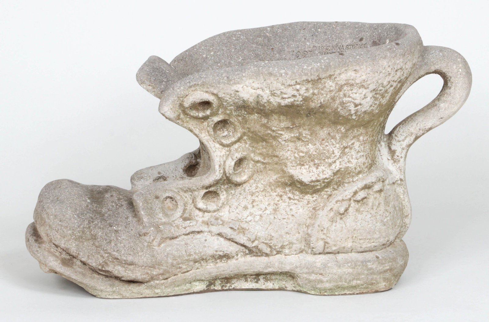 Large cast stone shoe planter: Large cast stone shoe planter, stamped Nina Studios, Quakertown, PA. 14-1/4, 26''w, 14''d.