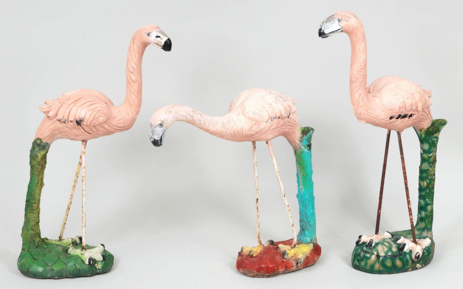 Group of (3) cast stone garden flamingos: Group of (3) cast stone garden flamingos, painted in vibrant colors. Paint loss, repairs. Tallest 32-1/4''h.