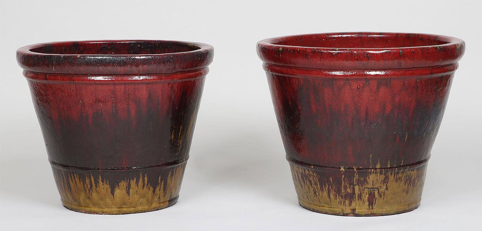 Pair of large glazed earthenware planters: Pair of large glazed earthenware planters. 18''h, 22''dia.