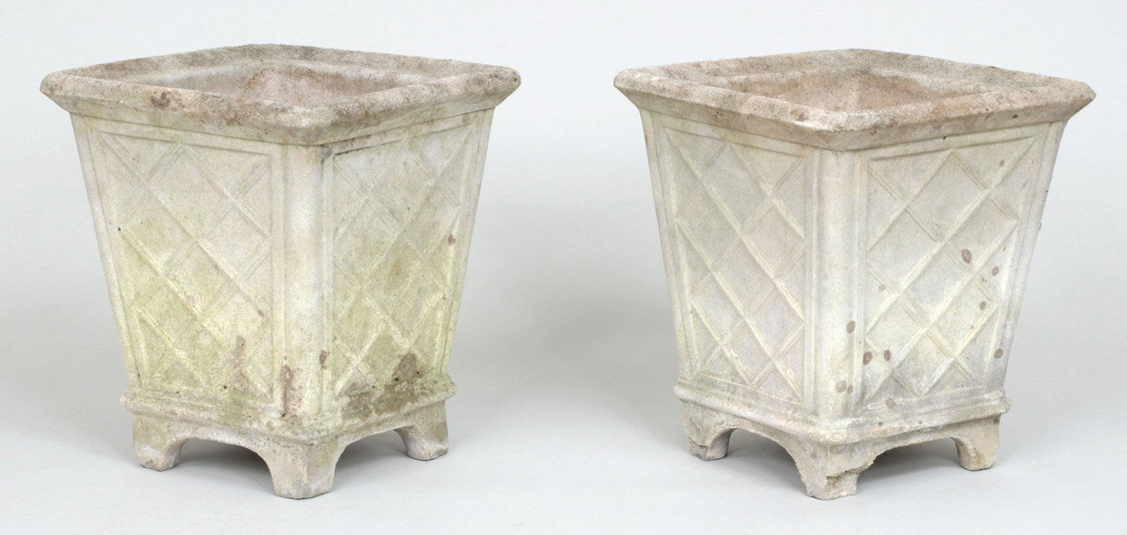Pair of square cast stone planters: Pair of square cast stone planters with lattice relief pattern to sides. Minor hairline to rim, small chips to feet. 16-1/4h, 14-1/2''sq.